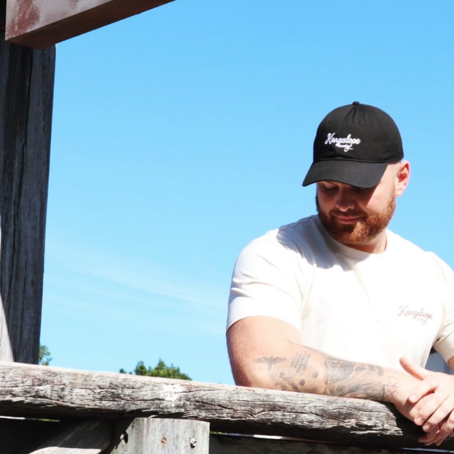 Man wearing Kangalope dad cap over gate